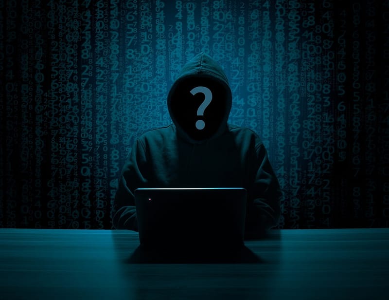 anonymous person sitting at computer | Quantropi